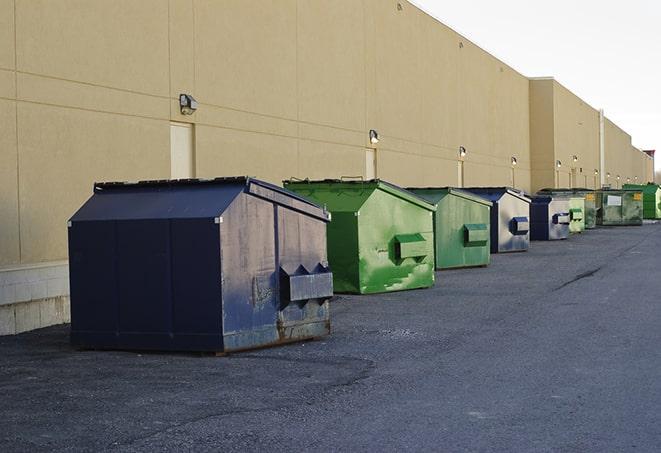 metal waste containers sit at a busy construction site in Crowder MS